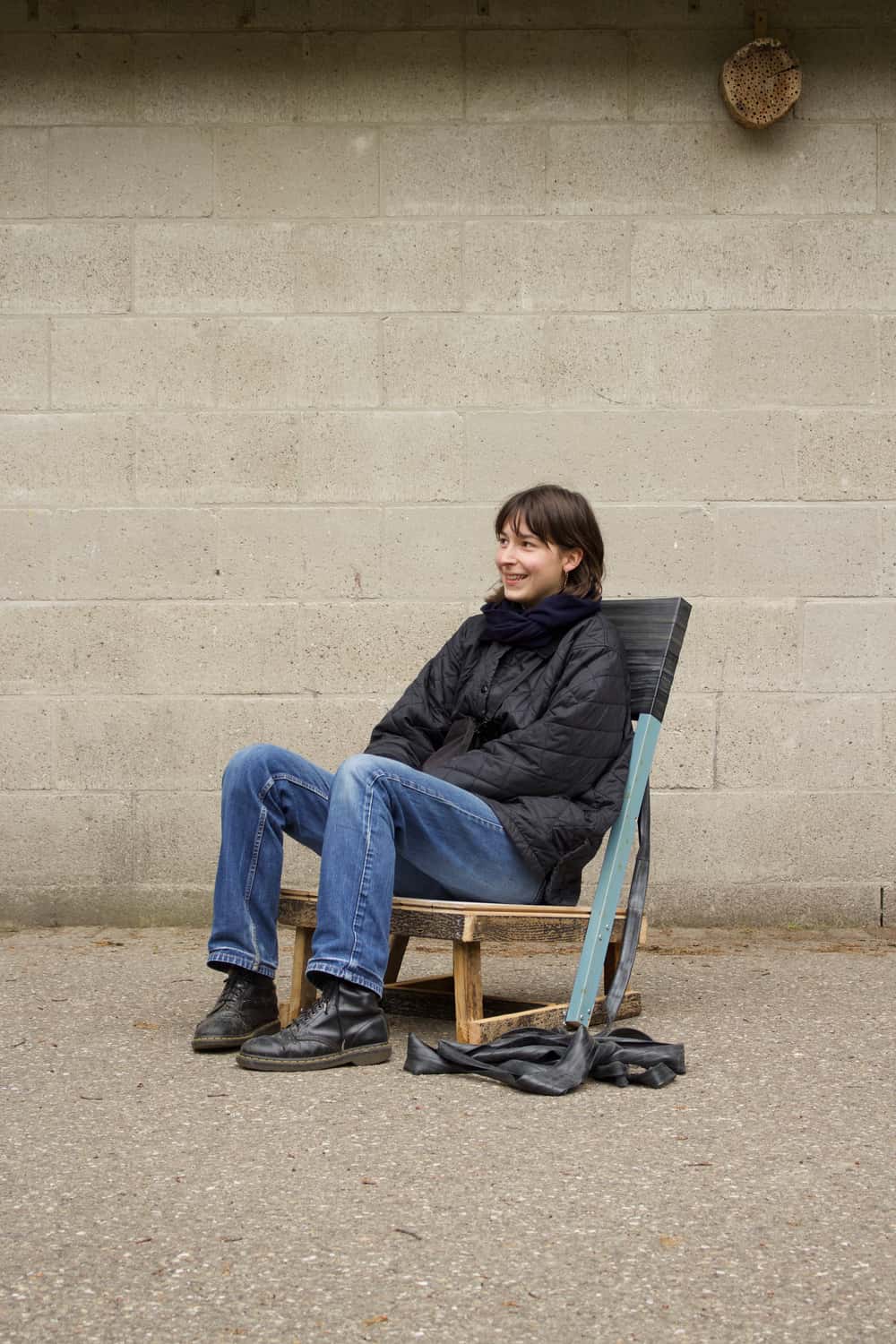 Anna is seating on a chair made of bike inner tubes